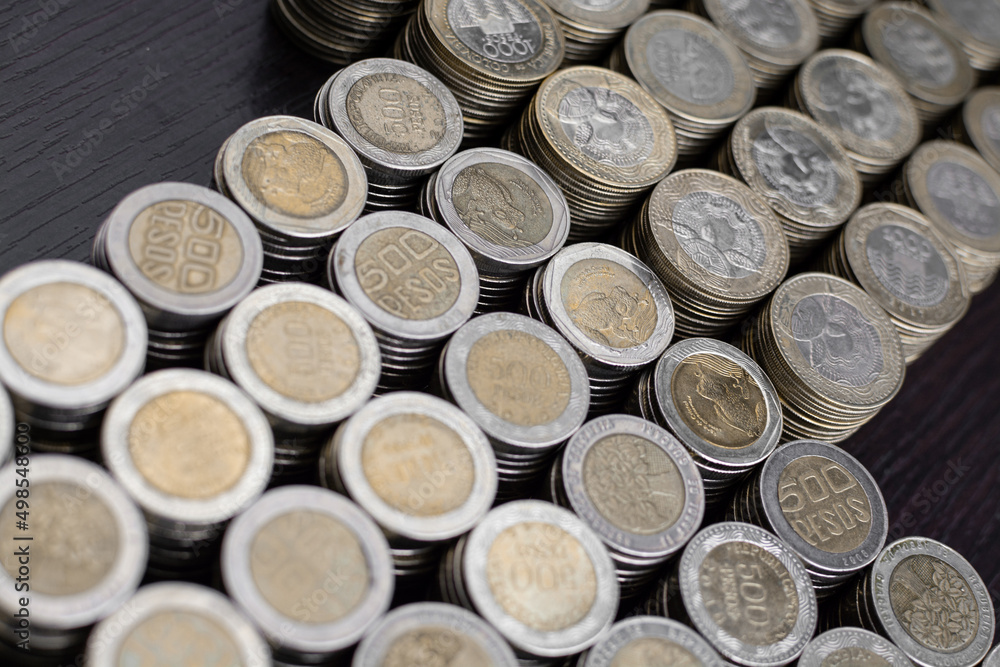 Pile of Colombian coins of 500 and 1000 denominations over wooden background. Ideal for economy, money, banks, save money and finance.
Pile of Colombian coins of 500 and 1000 denominations over wooden background. Ideal for economy, money, banks, save money and finance.