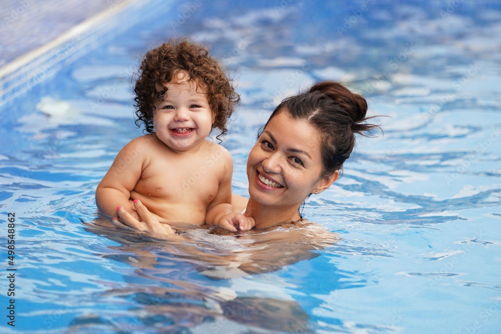 Mother and baby having fun in a swimming pool Mother and baby having fun in a swimming pool