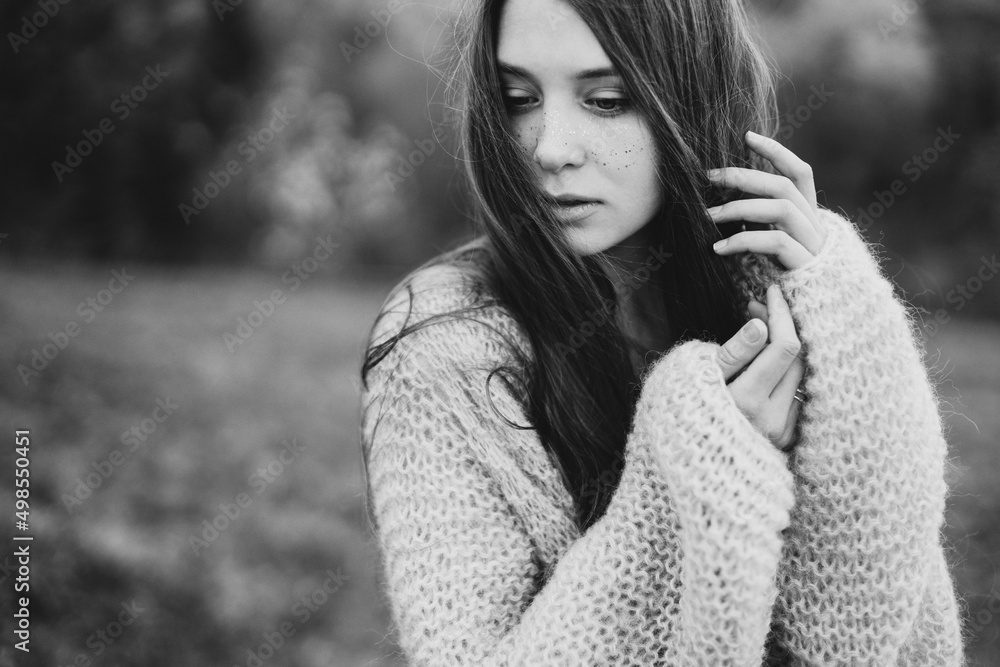 Young pretty emotional caucasian woman with long hair wearing natural makeup in romantic casual clothes walking among spring mountains near the beautiful fresh blooming tree in the countryside. Young pretty emotional caucasian woman with long hair wearing natural makeup in romantic casual clothes walking among spring mountains near the beautiful fresh blooming tree in the countryside.