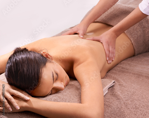 Stress be gone. Shot of a beautiful young woman enjoying a relaxing massage.