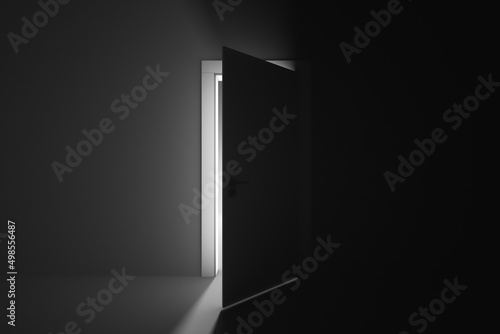 Ajar door to a mysterious brightly lit room photo