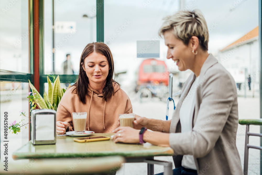 Two female friends drinking coffee and enjoying time Two female friends drinking coffee and enjoying time
