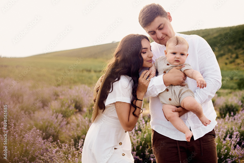 Beautiful young family in a lavender field spends the day Beautiful young family in a lavender field spends the day