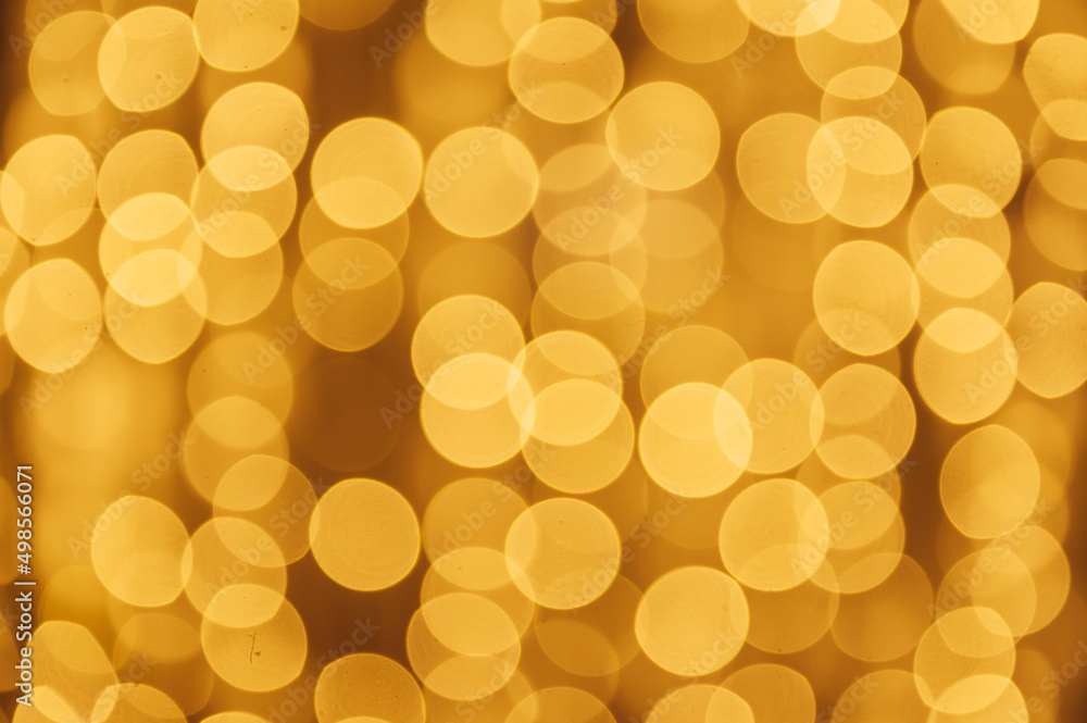 Abstract defocused yellow light on black background. Bokeh photo of LED light. Abstract defocused yellow light on black background. Bokeh photo of LED light.