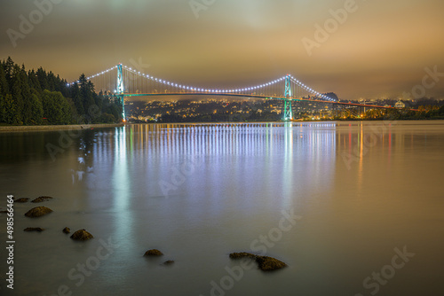 Beautiful view of Lions gate bridge over a river at night photo
