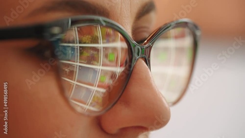 Business woman looking for content in stock video and photos. Stock content reflection on eyeglases from pc screen. Business marketing for companies. photo