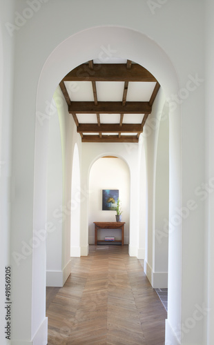 Arched hallway with wooden beam ceiling