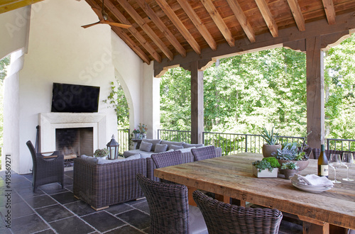 Outdoor room with dining table and fireplace