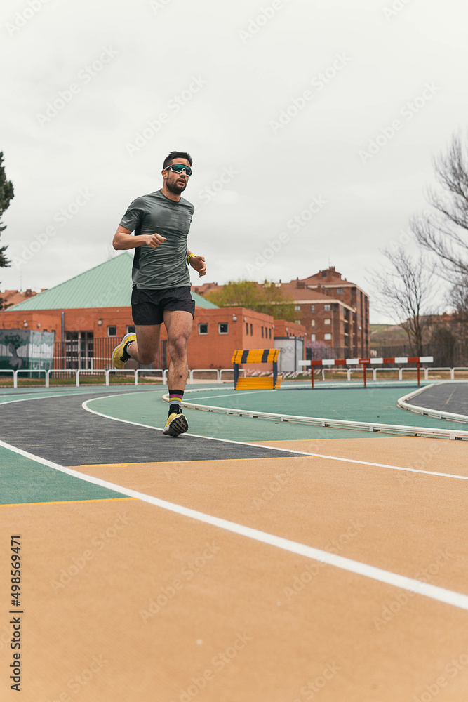man running on a running track