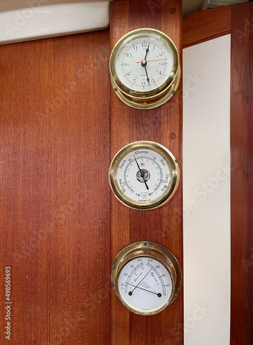 antique clock, thermometer and barometer un sailboat´s interior