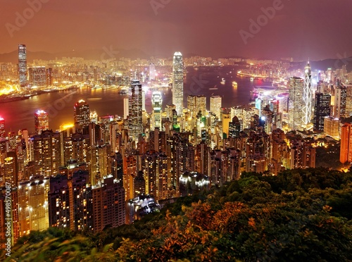 Night scenery of Hong Kong viewed from top of Victoria Peak with city skyline of crowded skyscrapers along Victoria Harbour and Kowloon area across seaport   Beautiful cityscape of Hongkong at sunset