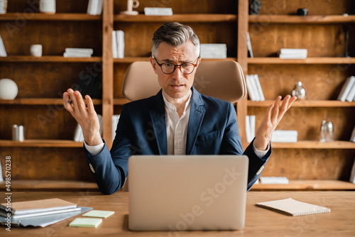Bild auf Leinwand Angry sad caucasian mature middle-aged businessman boss employee freelancer ceo making mistake error, being fired, deadline at work on laptop