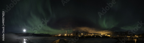 Full moon and aurora borealis over Carcross, Yukon Canada with Bennett Lake in winter photo