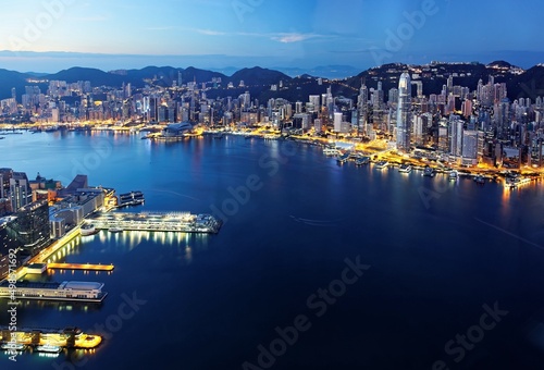 Morning scenery of Hong Kong & Kowloon before sunrise with city skyline of crowded skyscrapers by Victoria Harbour & ships between Tsim Sha Tsui & Central Ferry Piers ~ Beautiful cityscape of Hongkong
