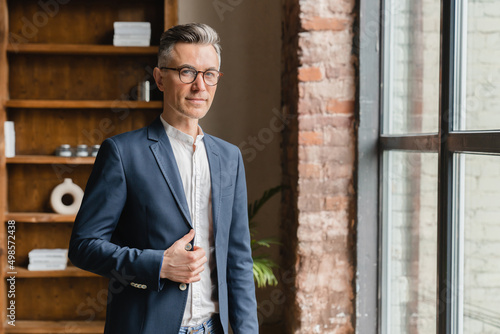 Rich successful caucasian mature middle-aged businessman boss ceo financial adviser lawyer looking at the window in office, working remotely at home © InsideCreativeHouse