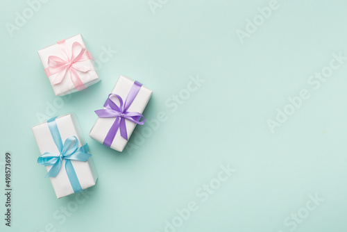 Colorful gift boxes on color background, top view