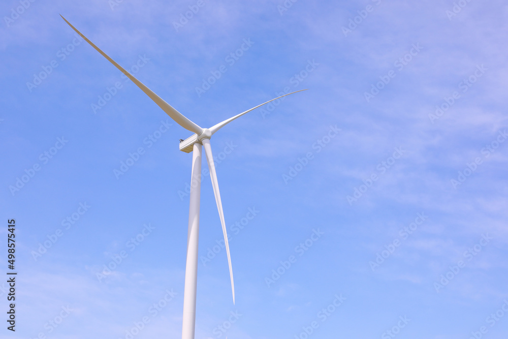 Wind turbines against the backdrop of a sunny sky. Green ecological energy generation. Eco field wind farm Wind turbines against the backdrop of a sunny sky. Green ecological energy generation. Eco field wind farm