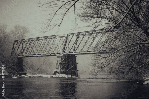 Grayscale shot of a bridge over a river in Menomonie, Wisconsin photo