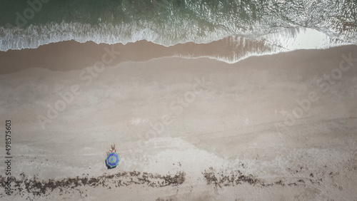Aerial top shot of Vero beach with one person resting on the beach in Florida, United States photo
