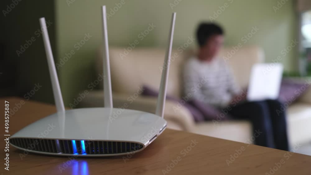 Internet Router Man Selective focus at router. Internet router on working table with ...