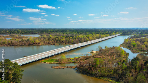 Aerial drone shot of Lake Houston with a road above in Kingwood, Texas, United States