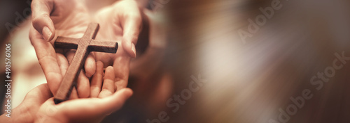 Woman's hand with cross .Concept of hope, faith, christianity, religion, church online. photo