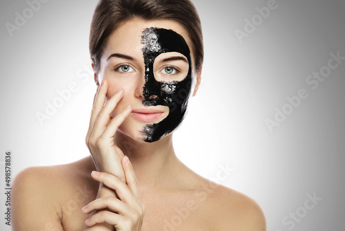 Woman with deep cleansing black mask on her face photo