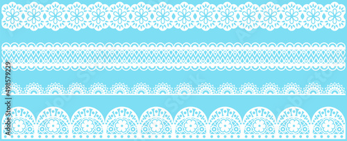 Set of wide lace ribbons with print. White design elements isolated on blue background. Seamless pattern for creating style of card with ornaments. Lace decoration template, ribbons for design