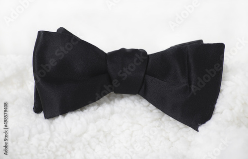 Murais de parede Closeup shot of black bow tie on white background