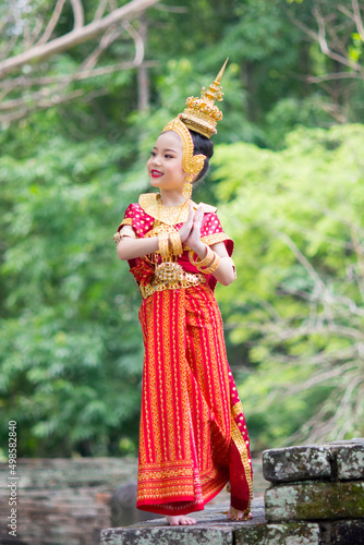 Asian young girl wearing typical  traditional Thai Dress. Red and gold traditional dancing.