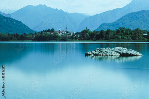 Beautiful landscape of Alserio lake against mountains and blue sky in bright sunlight in Como, Italy photo