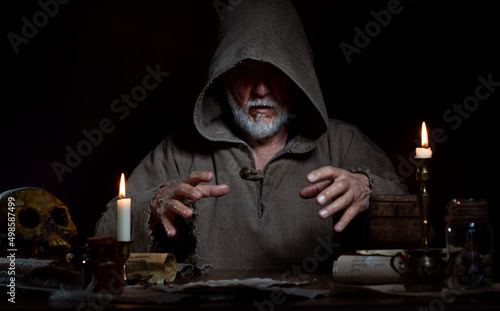 Old wizard does magic. Product placement free. photo