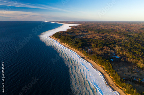 Scenic landscape of shore of Baltic sea at winter. Snow on sand. © Aleks Kend