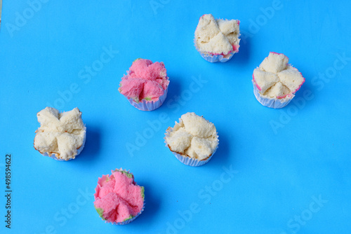 Steamed sponge cake, or bolu kukus food from Indonesia. isolated on a blue background photo