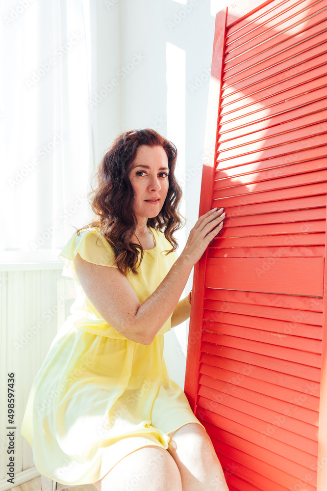 beautiful woman in a yellow summer dress