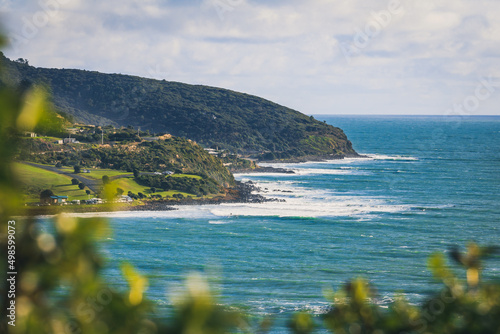 Beautiful view of the cliffs at Ngarunui Beach against blue sky on a sunny day, Raglan, New Zealand photo