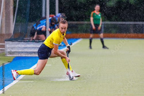 Female field hockey player performing penalty shot 