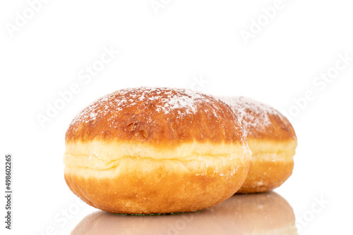 Two sweet donuts stuffed with jam, macro, isolated on a white background.