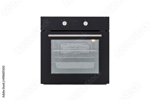 Black oven with closed door and with two control knobs and luminous electronic display, front view, isolate on white