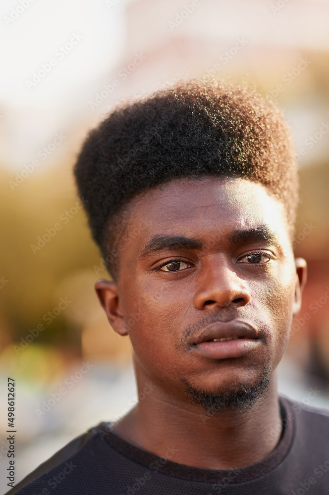 Reviving the high top fade. Portrait of a young man with high top fade posing outdoors.