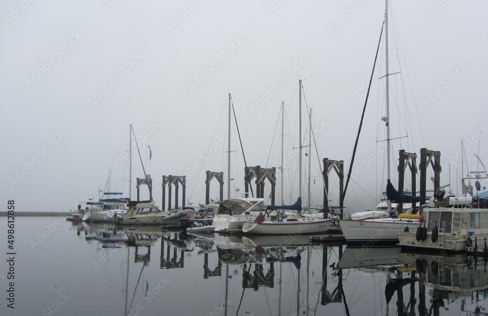 boats in the harbor on a foggy morning