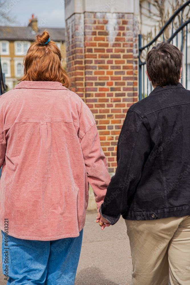 Lesbian couple walking holding hands. Lesbian couple walking holding hands.