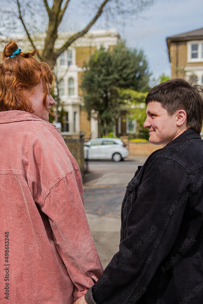Lesbian couple walking holding hands. Lesbian couple walking holding hands.