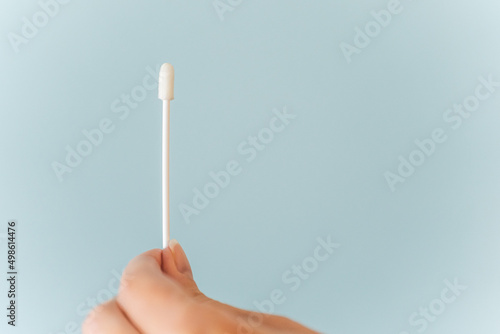 Bild auf Leinwand Hand holds Covid-19 PCR nasal swab against background with copy space