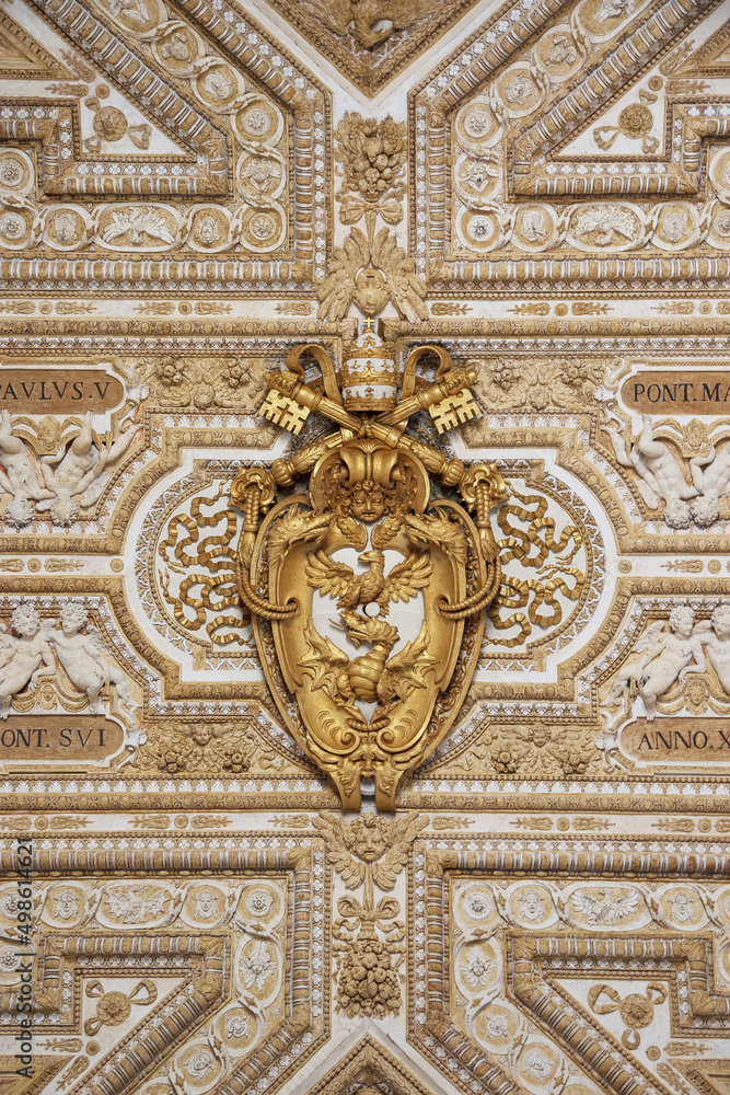 White and gold antique decorative baroque detail with golden eagle, keys and Papal tiara