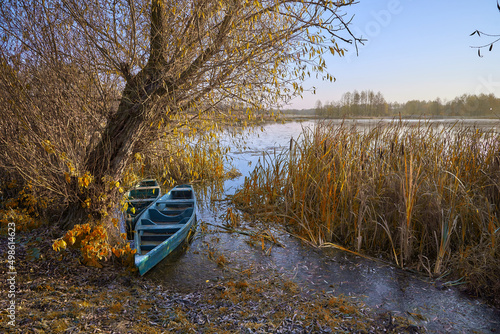 two boats in the bush on the river in the autumn moning in Ukraine	 photo