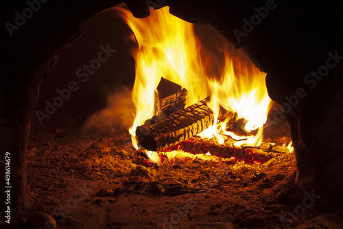 Flaming wood in an open oven, burning firewood in a fireplace