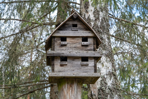 big birdhouses on rustic wooden fence. close up of beautiful colored wooden bird house © Sandris