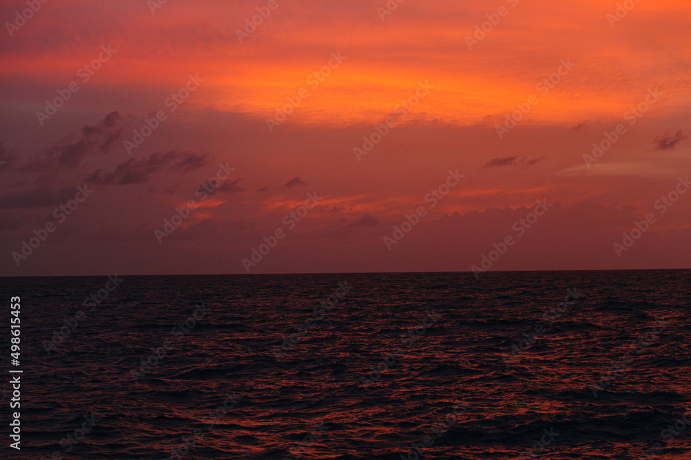 ocean at sunset, not big waves, horizontal