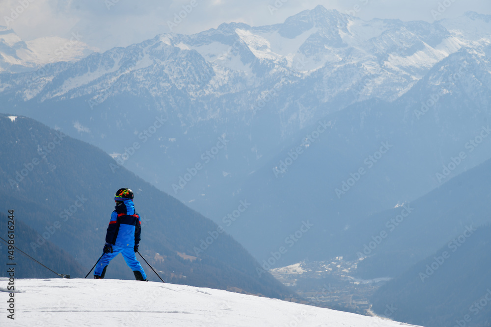 Kid skier on the top of the mountain at Pejo Ski Resort in Val di Sole valley, Italy. Europe.